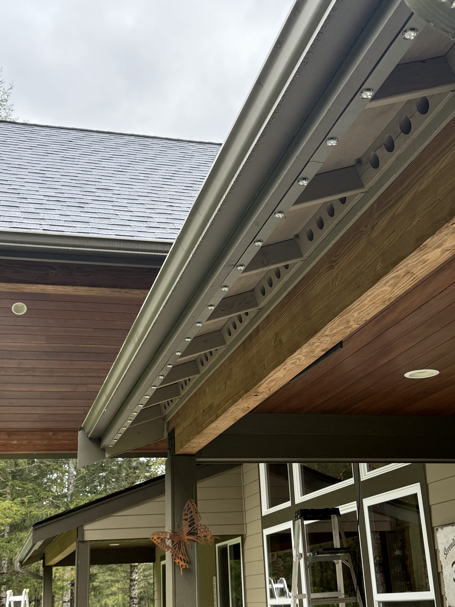 Technician installing permanent LED lights on eaves